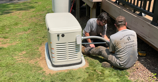 two technicians working on a generator repair